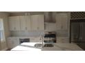 Modern kitchen featuring an island, stainless steel appliances, and white cabinetry at 2085 Dellwood, Decatur, GA 30032