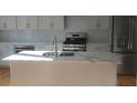 Modern kitchen featuring an island, stainless steel appliances, and white cabinetry at 2085 Dellwood, Decatur, GA 30032
