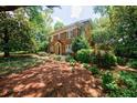 A view of this brick home highlighting its architectural style and mature landscaping at 27 S Avondale Rd, Avondale Estates, GA 30002