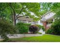 Charming white brick home featuring a well-maintained lawn and front porch at 626 Elmwood Ne Dr, Atlanta, GA 30306