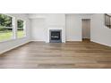 Bright living room showcasing hardwood floors, fireplace, and large windows at 1911 Fairchild Ave, Grayson, GA 30017