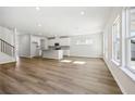 Spacious open-concept living area with hardwood floors, a modern kitchen, and large windows at 1911 Fairchild Ave, Grayson, GA 30017