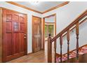 Bright foyer with wood floors, stairs, and a beautiful wooden front door with sidelight windows at 200 Zachary Woods Nw Pt, Marietta, GA 30064
