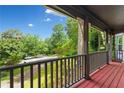 Inviting covered porch with wooden floors, railing, decorative supports and view of the landscaped front yard at 200 Zachary Woods Nw Pt, Marietta, GA 30064