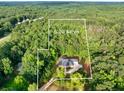 Expansive 6.2 acre lot featuring lush greenery and mature trees, offering privacy at 338 Mount Zion Rd, Oxford, GA 30054