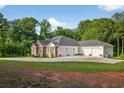 Spacious home exterior featuring a large driveway leading to a three-car garage at 338 Mount Zion Rd, Oxford, GA 30054