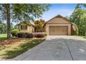 Charming one-story home with manicured lawn, mature trees, and two-car garage at 601 Laurel Xing, Canton, GA 30114