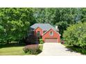 Well-maintained two-story brick home with a two-car garage and manicured landscaping at 109 Lake Latimer Ne Cv, Kennesaw, GA 30144