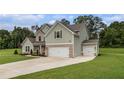 Spacious two-story home with a three-car garage, lush green lawn, and inviting curb appeal at 2 Whites Pond Rd, Moreland, GA 30259