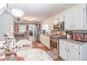 Functional kitchen with white cabinets, granite counters, and stainless steel appliances at 3152 H D Atha Rd, Covington, GA 30014