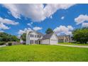 Classic two-story home with a green lawn, showcasing its welcoming curb appeal at 5916 Farmbrook Ln, Rex, GA 30273