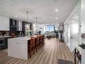 Bright kitchen with open layout, large island, and adjacent living space with access to the deck at 788 W Marietta Nw St # 308, Atlanta, GA 30318