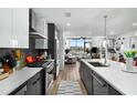 Sleek kitchen with stone countertops, stainless appliances, and view of open living area at 788 W Marietta Nw St # 308, Atlanta, GA 30318