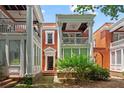 Elegant brick townhome showcases stately white columns, inviting balconies, and a well-manicured front yard at 872 Briarcliff Ne Rd # B2, Atlanta, GA 30306