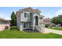 Attractive home featuring a stone staircase, a well-kept lawn, and a stucco facade at 113 Garden Walk, Stockbridge, GA 30281