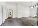 Bright living room with neutral carpet, ceiling fan, and fresh white paint at 1365 Athens Sw Ave, Atlanta, GA 30310