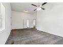 Open living space featuring a ceiling fan, new carpet, and natural light at 1365 Athens Sw Ave, Atlanta, GA 30310