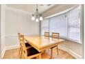 Bright dining room with a chandelier and large windows offering natural light at 306 Autumn Leaf Way, Norcross, GA 30093