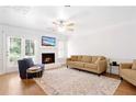 Cozy living room with fireplace, plush seating, and hardwood floors at 306 Autumn Leaf Way, Norcross, GA 30093