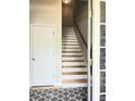Inviting entryway with staircase and patterned rug; a classic design for a warm welcome at 3473 Newtons Crest Cir, Snellville, GA 30078