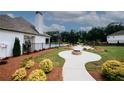 Expansive backyard featuring a pool, fire pit, and playground, perfect for outdoor entertaining and relaxation at 3579 Silvery Way, Powder Springs, GA 30127