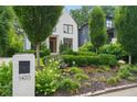 Charming home displaying manicured garden beds and a lush lawn at 1433 Wessyngton Ne Rd, Atlanta, GA 30306