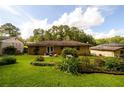 Spacious backyard featuring a lush lawn, various plants, and a partial fence at 1472 High Meadow Dr, Stone Mountain, GA 30083