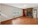 Cozy living room with a brick fireplace, built-in bookshelves, and bright natural light at 1913 Ferry Dr, Marietta, GA 30066