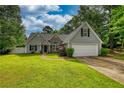 Charming single-Gathering home with a well-maintained lawn and attached two-car garage at 556 Walton Dr, Social Circle, GA 30025