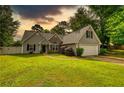 Charming single-Gathering home with a well-maintained lawn and attached two-car garage at 556 Walton Dr, Social Circle, GA 30025