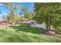 Lovely single-Gathering home with carport surrounded by lush greenery at 1703 Barrett Nw Dr, Atlanta, GA 30318