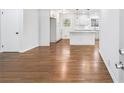 Open-concept living room with hardwood floors flowing into a modern, bright kitchen at 1703 Barrett Nw Dr, Atlanta, GA 30318