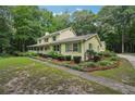 A charming two-story home featuring a long driveway surrounded by lush greenery and trees at 2110 Waterloo Cir, Lawrenceville, GA 30043