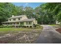 A charming two-story home featuring a long driveway surrounded by lush greenery and trees at 2110 Waterloo Cir, Lawrenceville, GA 30043