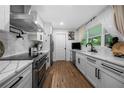 Bright kitchen boasts stainless steel appliances, sleek white cabinets, and wood grain flooring at 2432 Kelly Lake Dr, Decatur, GA 30032