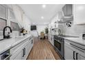 Open-concept kitchen with stainless appliances, white cabinets, and a view into the dining area at 2432 Kelly Lake Dr, Decatur, GA 30032