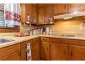 Close up of the kitchen showcasing wooden cabinets, laminate countertops, and a double basin sink at 265 Forest Lake Dr, Covington, GA 30016