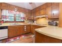 Functional kitchen with wooden cabinets, laminate countertops, and a white dishwasher at 265 Forest Lake Dr, Covington, GA 30016