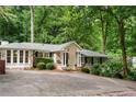 Attractive home with manicured shrubs, brick accents, and a welcoming front entrance, set on a driveway at 5114 N Ivy Ne Rd, Atlanta, GA 30342