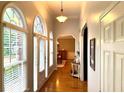 Inviting hallway with hardwood floors and arched windows offering natural light at 753 Summer Ridge Dr, Villa Rica, GA 30180