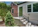 Inviting front entrance with a decorative green door, brick accents, and freshly landscaped yard at 1131 Forrest Blvd, Decatur, GA 30030
