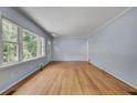 Spacious living room boasts hardwood floors, natural light, and neutral colored walls at 1131 Forrest Blvd, Decatur, GA 30030