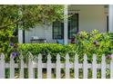 Landscaped front yard featuring a white picket fence, lush greenery, and a cozy porch swing at 174 Pearl Se St, Atlanta, GA 30316