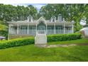 Inviting home featuring a quaint front porch and lush, green landscaping at 3358 Lake Dr, Lawrenceville, GA 30044