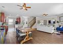 Open floor plan with dining area flowing into the living room and kitchen with a breakfast bar and stairs at 4020 New Salem Ct, Cumming, GA 30040