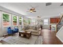 Open-concept living area featuring hardwood floors, a fireplace, and a seamless transition to the dining area at 4020 New Salem Ct, Cumming, GA 30040