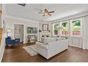 Bright living room featuring a fireplace, hardwood floors, and large windows providing ample natural light at 4020 New Salem Ct, Cumming, GA 30040