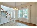 Inviting entryway with wood-look tile flooring and staircase at 1504 Terminal Ct, Mcdonough, GA 30252