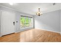 Bright dining room with a chandelier, large window, and hardwood floors at 305 Mill Pond Se Ct, Smyrna, GA 30082