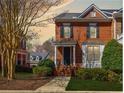 Charming two-story brick townhouse with manicured front yard, garden, shutters, and classic architectural details at 5210 Davenport Pl, Roswell, GA 30075